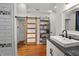 Bathroom featuring a barn door, shelves, wood floors and a sleek vanity at 1627 Pleasant St, Indianapolis, IN 46203