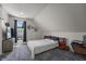 Cozy bedroom featuring a queen-size bed, gray carpet, a TV, and natural light at 1627 Pleasant St, Indianapolis, IN 46203