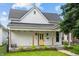 Charming home featuring a cheerful yellow front door, porch and well-maintained front lawn at 1627 Pleasant St, Indianapolis, IN 46203