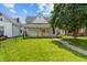 Exterior view of the home with a well-manicured lawn, black fence and lovely landscaping at 1627 Pleasant St, Indianapolis, IN 46203