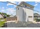 Detached two-story garage with a private entrance and an extended concrete driveway at 1627 Pleasant St, Indianapolis, IN 46203