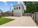 Exterior view of a detached two-story garage with a private entrance and a concrete driveway at 1627 Pleasant St, Indianapolis, IN 46203