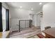Hallway with light wood floors, black railing, and white trim provides access to multiple rooms at 1627 Pleasant St, Indianapolis, IN 46203
