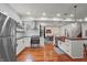 Open kitchen with stainless steel appliances, white cabinets, wood counters and hardwood floors at 1627 Pleasant St, Indianapolis, IN 46203