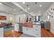 Open concept kitchen with island, copper sink, stainless appliances, and hardwood floors at 1627 Pleasant St, Indianapolis, IN 46203
