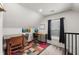 Bright office space with a window, a desk with metal drawers and a colorful rug at 1627 Pleasant St, Indianapolis, IN 46203