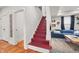 Painted red stairs lead up to the main living area with a blue sofa at 1627 Pleasant St, Indianapolis, IN 46203