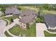 Aerial view of a luxury home, manicured lawn and a lush green golf course at 16332 Valhalla Dr, Noblesville, IN 46060