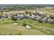 Gorgeous aerial view of a house nestled within a golf course community with lush fairways, ponds, and manicured lawns at 16332 Valhalla Dr, Noblesville, IN 46060