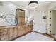 Bright bathroom features a double sink vanity with granite countertops, decorative rug, and stylish light fixtures at 16332 Valhalla Dr, Noblesville, IN 46060