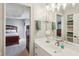 Bright bathroom features a modern sink, light fixtures, and view to adjacent bedroom at 16332 Valhalla Dr, Noblesville, IN 46060