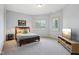 A cozy bedroom features soft lighting, two shuttered windows and a flat screen tv at 16332 Valhalla Dr, Noblesville, IN 46060