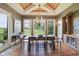 Charming dining room featuring hardwood floors, large windows, modern lighting, and stylish decor at 16332 Valhalla Dr, Noblesville, IN 46060