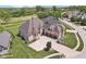 Beautiful stone home with a three-car garage and well-maintained landscaping on a manicured lawn next to a golf course at 16332 Valhalla Dr, Noblesville, IN 46060