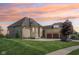 Stunning stone home featuring a spacious driveway and an attached three-car garage at 16332 Valhalla Dr, Noblesville, IN 46060