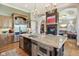 Kitchen island with stainless steel appliances, granite countertop, and view into the living room at 16332 Valhalla Dr, Noblesville, IN 46060