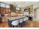 Gourmet kitchen features a large center island, stone accent wall, stainless steel appliances, and custom cabinetry at 16332 Valhalla Dr, Noblesville, IN 46060