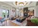 Bright and airy living room with hardwood floors, a stone fireplace, and views to the outdoor at 16332 Valhalla Dr, Noblesville, IN 46060