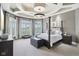 Spacious main bedroom with a four-poster bed, sitting area, and large windows offering scenic views at 16332 Valhalla Dr, Noblesville, IN 46060