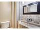 Stylish powder room features decorative tiling, stone sink, and modern faucet at 16332 Valhalla Dr, Noblesville, IN 46060