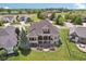 Beautiful backyard view of a stone home featuring a covered patio and pristine landscaping, offering serene outdoor living at 16332 Valhalla Dr, Noblesville, IN 46060