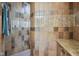 Tiled shower area with a built-in seat, hand-held shower head and shelving at 16332 Valhalla Dr, Noblesville, IN 46060