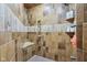 Walk-in shower with elegant tiling, a built-in seat, shelving, and multiple shower heads at 16332 Valhalla Dr, Noblesville, IN 46060