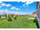 The backyard offers lush green grass and a partial view of the back of the house at 1704 Beach St, Greenwood, IN 46143