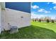 Lush green grass surrounds the back of this two-story home, with a partial view of the white brick exterior at 1704 Beach St, Greenwood, IN 46143