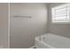 Bright bathroom featuring a white bathtub with tile surround and chrome fixtures at 1704 Beach St, Greenwood, IN 46143