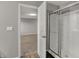 Shower with sliding door inside a bathroom; door leads to carpeted bedroom at 1704 Beach St, Greenwood, IN 46143
