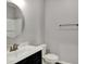This bathroom features a single sink vanity, toilet, and a shower at 1704 Beach St, Greenwood, IN 46143