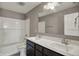Bathroom featuring a double sink vanity with white countertop and shower-tub combination at 1704 Beach St, Greenwood, IN 46143