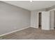 Spacious bedroom with neutral carpet, closet, and doorway to other rooms at 1704 Beach St, Greenwood, IN 46143