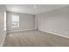 Bedroom featuring neutral carpet, window with blinds, and a entry doorway at 1704 Beach St, Greenwood, IN 46143