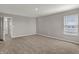 Bedroom featuring neutral carpet, a window with blinds, and open doorway at 1704 Beach St, Greenwood, IN 46143