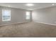 Spacious carpeted bedroom with lots of natural light from dual windows at 1704 Beach St, Greenwood, IN 46143