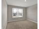 Carpeted bedroom with a window that lets in natural light at 1704 Beach St, Greenwood, IN 46143