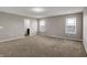 Open carpeted bedroom boasting large windows, neutral walls, and recessed lighting at 1704 Beach St, Greenwood, IN 46143