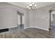 Charming dining room with hardwood floors, modern chandelier, and seamless flow to other living spaces at 1704 Beach St, Greenwood, IN 46143