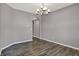 Cozy dining room with stylish hardwood floors, modern chandelier, and neutral paint, creating a welcoming atmosphere at 1704 Beach St, Greenwood, IN 46143