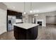 Open concept kitchen featuring dark wood cabinets, stainless appliances, and a living room at 1704 Beach St, Greenwood, IN 46143