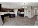 Open concept kitchen features dark cabinets, stainless steel appliances, and an island at 1704 Beach St, Greenwood, IN 46143