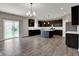 Open kitchen featuring dark wood cabinets, white backsplash, and a center island with white countertop at 1704 Beach St, Greenwood, IN 46143