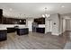 Open kitchen featuring dark wood cabinets, white backsplash, and a center island with white countertop at 1704 Beach St, Greenwood, IN 46143