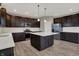 Spacious kitchen featuring dark wood cabinets, stainless appliances, and a center island with white countertop at 1704 Beach St, Greenwood, IN 46143
