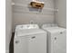 Convenient laundry room features modern Maytag appliances and shelving for storage at 1704 Beach St, Greenwood, IN 46143