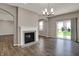 Bright living room featuring an elegant fireplace, arched doorways, and hardwood floors at 1704 Beach St, Greenwood, IN 46143