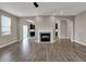 Bright living room with ceiling fan, fireplace, and hardwood floors at 1704 Beach St, Greenwood, IN 46143