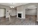 Bright living room featuring an elegant fireplace, arched doorways, and hardwood floors at 1704 Beach St, Greenwood, IN 46143